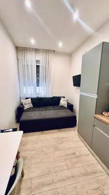 a small bedroom with a bed and a refrigerator at Bold apartment 2 in Rome