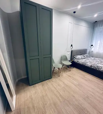 a bedroom with a sliding door and a bed and chairs at Bold apartment 2 in Rome