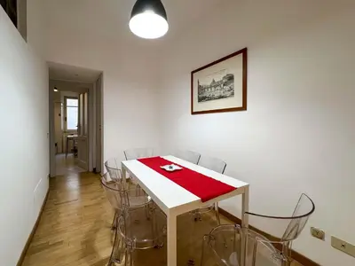a dining room with a white table and chairs at JHHIT - San Pietro First Suite in Rome