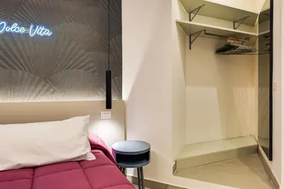 a bedroom with a purple couch and a stool at Belli Vatican Suites by Flatinrome in Rome