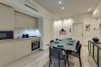 a kitchen and dining room with a table and chairs at Belli Vatican Suites by Flatinrome in Rome