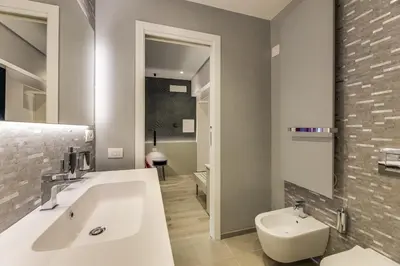 a bathroom with a white sink and a toilet at Belli Vatican Suites by Flatinrome in Rome