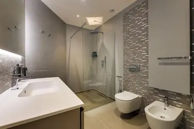 a bathroom with a sink and a toilet and a shower at Belli Vatican Suites by Flatinrome in Rome
