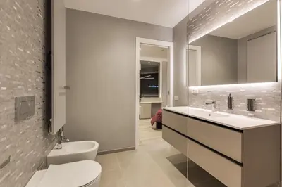 a bathroom with a white toilet and a sink at Belli Vatican Suites by Flatinrome in Rome