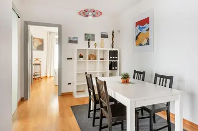 a dining room with a white table and chairs at Private Condo Terrace & Parking in Rome