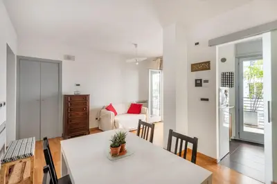 a living room with a table and a couch at Private Condo Terrace & Parking in Rome