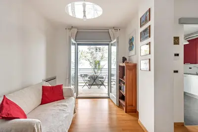 a living room with a couch and a kitchen at Private Condo Terrace & Parking in Rome