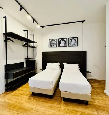 a bedroom with two beds and a staircase at Museum Hospitality - Vatican Apartments in Rome