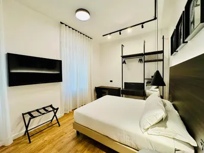 a bedroom with a bed and a tv on the wall at Museum Hospitality - Vatican Apartments in Rome