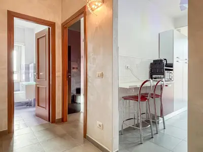 a kitchen with a counter and stools in a room at Portuense Paradise in Rome