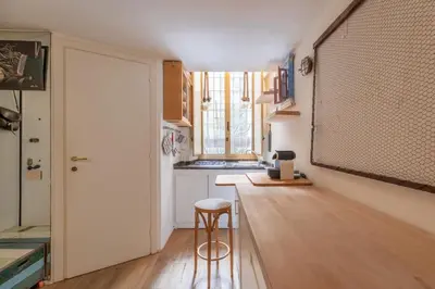 a kitchen with a counter and a stool in a room at iFlat Monti Studio Apartment in Rome