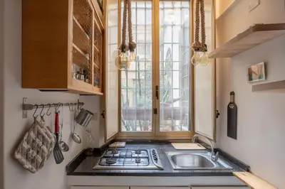 a kitchen with a sink and a window at iFlat Monti Studio Apartment in Rome