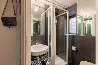 a bathroom with a sink and a shower at iFlat Monti Studio Apartment in Rome
