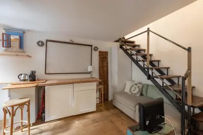 a room with a classroom with a desk and a staircase at iFlat Monti Studio Apartment in Rome