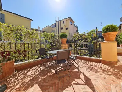 a table and chairs sitting on a patio at CS Stylish Loft with Terrace Spanish Steps in Rome