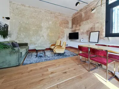 a living room with a couch and a table at CS Stylish Loft with Terrace Spanish Steps in Rome