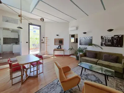 a living room with a couch and a table at CS Stylish Loft with Terrace Spanish Steps in Rome