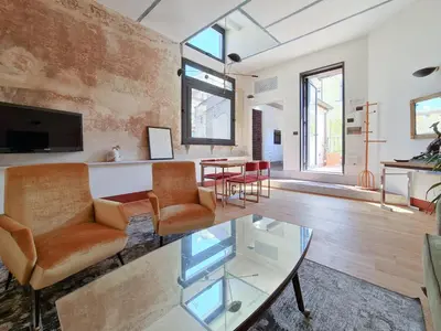 a living room with a glass table and chairs at CS Stylish Loft with Terrace Spanish Steps in Rome