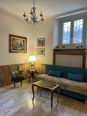 a living room with a couch and a table at Villa dei fiori in Rome