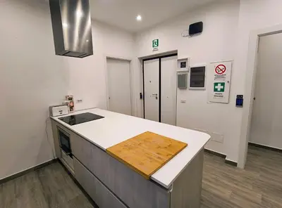 a kitchen with a wooden cutting board on a counter at San Pietro Experience in Rome
