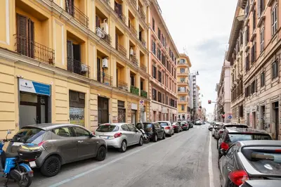 a row of parked cars on a city street at V HOME Termini in Rome