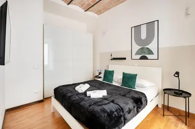 a bedroom with a large bed with green pillows at V HOME Termini in Rome