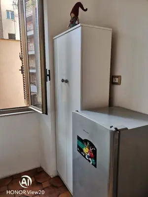 a bedroom with a bed and a flat screen tv at DuPigne' House in Rome