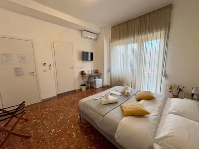 a bedroom with a large bed with towels on it at Quattro Venti city suites in Rome