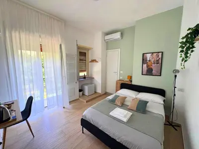 a bedroom with a bed and a desk in it at Quattro Venti city suites in Rome