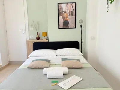 a bed with two pillows on it in a room at Quattro Venti city suites in Rome