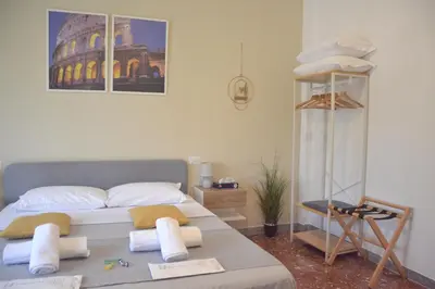 a bedroom with a bed with towels on it at Quattro Venti city suites in Rome