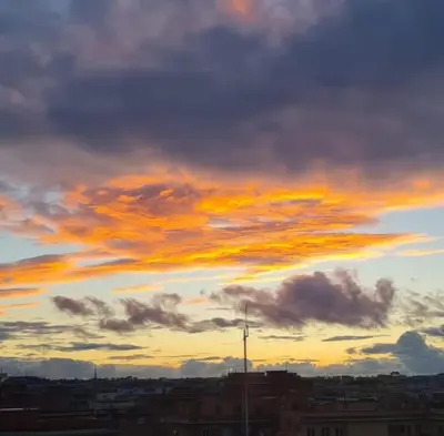 a cloudy sky at sunset over a city at L' attichetto in Rome