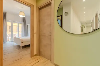 a hallway with a mirror and a room with a bed at Maria Magdalena Apartment Saint Peter's in Rome