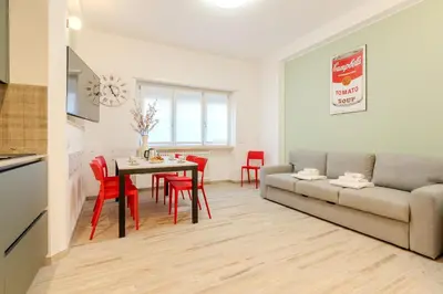 a living room with a couch and a table and chairs at Maria Magdalena Apartment Saint Peter's in Rome