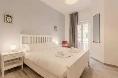 a white bedroom with a white bed and a window at Maria Magdalena Apartment Saint Peter's in Rome