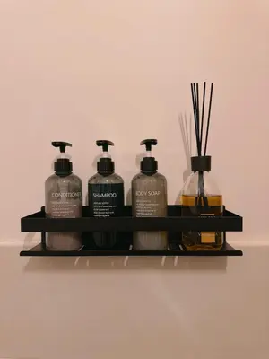 a shelf with four bottles of detergent andents on it at Vacanze Romane House in Rome