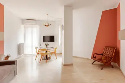 a living room with a table and a chair at Casa Bella in Rome