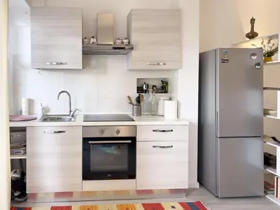 a kitchen with a refrigerator and a sink at Domus Lucis Rome in Rome
