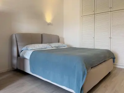 a bed with a blue blanket and pillows on it at Domus Lucis Rome in Rome