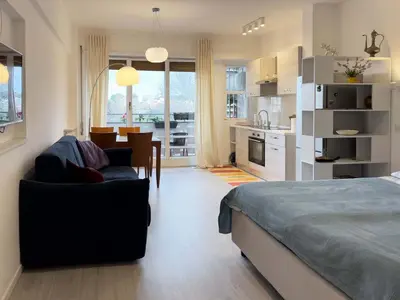 a bedroom with a bed and a living room and a kitchen at Domus Lucis Rome in Rome