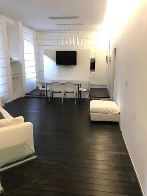 a living room with a table and chairs and a room with a tv at Vatican 3th Floor in Rome