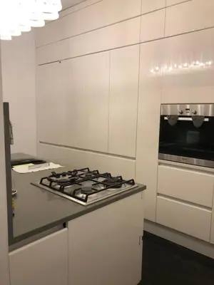 a white kitchen with a stove and a microwave at Vatican 3th Floor in Rome