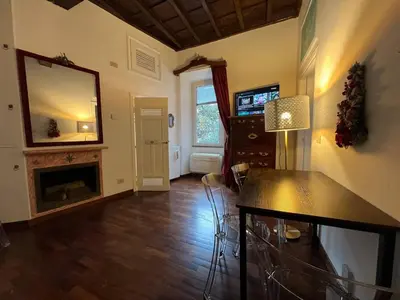 a living room with a table and a mirror at The Charm of Trastevere in Rome