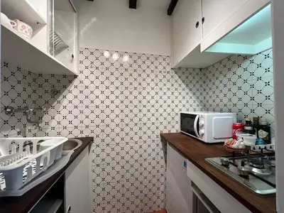 a kitchen with a sink and a microwave at The Charm of Trastevere in Rome
