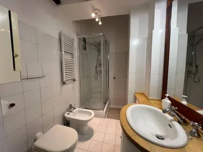 a bathroom with a sink and a toilet and a shower at The Charm of Trastevere in Rome