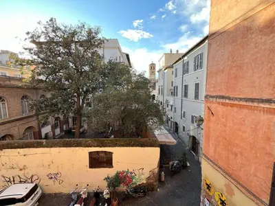 a group of people standing in an alley with a tree at The Charm of Trastevere in Rome