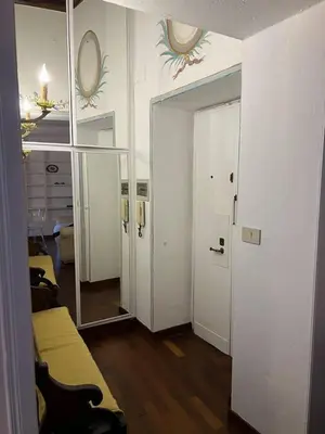 a room with a mirror and a room with a bed at The Charm of Trastevere in Rome