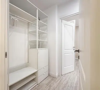 a white walk in closet with a white door at Vatican House Crocifisso 51 in Rome