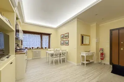 a kitchen and dining room with a table and chairs at Vatican House Crocifisso 51 in Rome