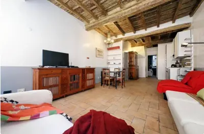 a living room with a couch and a tv at Limani - Campo de' Fiori Private Retreat in Rome